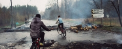 Local children on a road with destroyed barricades after the first assault by Ukrainian army of Ilovaysk. April 13, 2014, Slavyansk