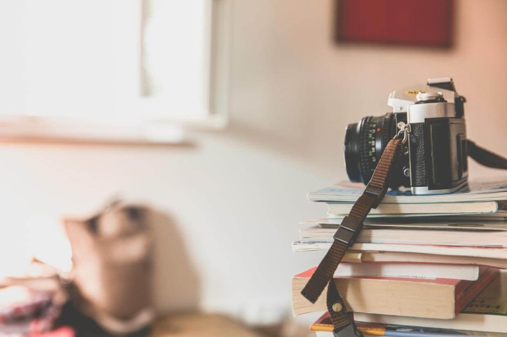 Camera sitting on a stack on books - how to make money as a landscape photographer